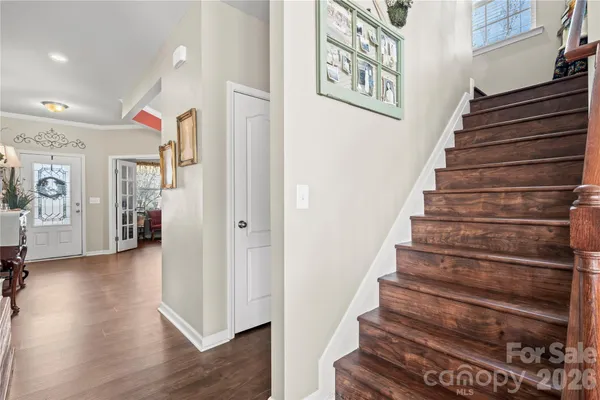 a view of entryway and hall with wooden floor