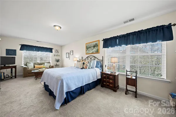 a bedroom with a bed and a couch