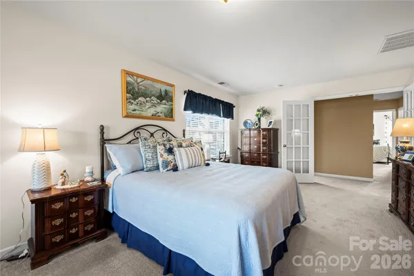 a bedroom with a large bed and a closet