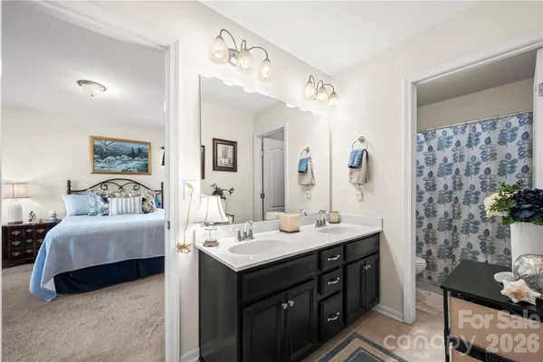 a spacious bathroom with a double vanity sink mirror and