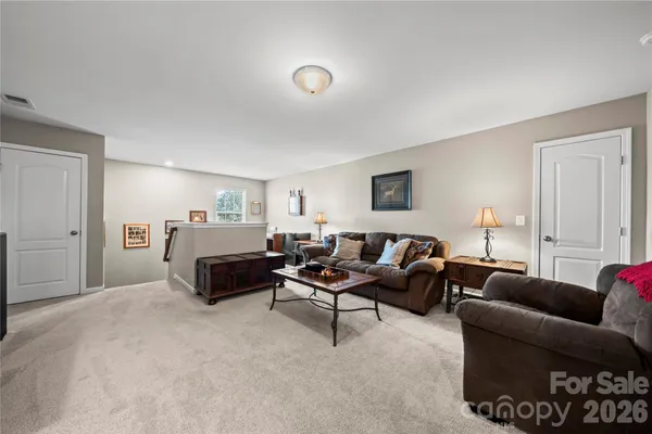 a living room with furniture a lamp and a window