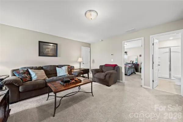 a living room with furniture and a night stand