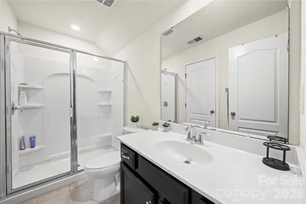 a bathroom with a double vanity sink a mirror and shower