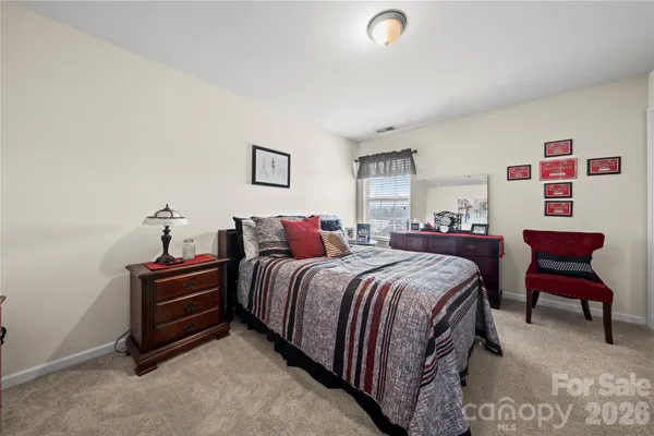 a bedroom with bed and a couch