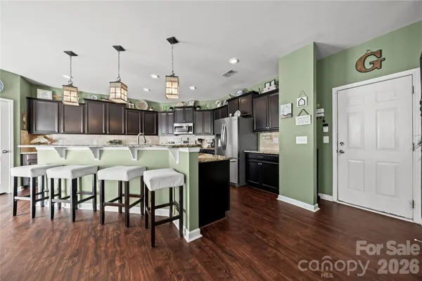 a large kitchen with lots of furniture and appliances