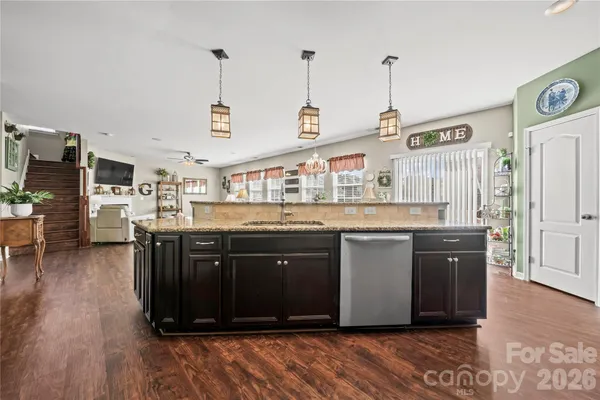a kitchen with stainless steel appliances granite countertop a stove a sink dishwasher and a refrigerator