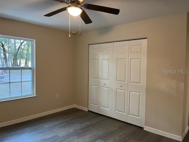 4366 Southeast 138th Street Summerfield, FL 34491 - Photo 13 of 23 an empty room with wooden floor cabinet and windows