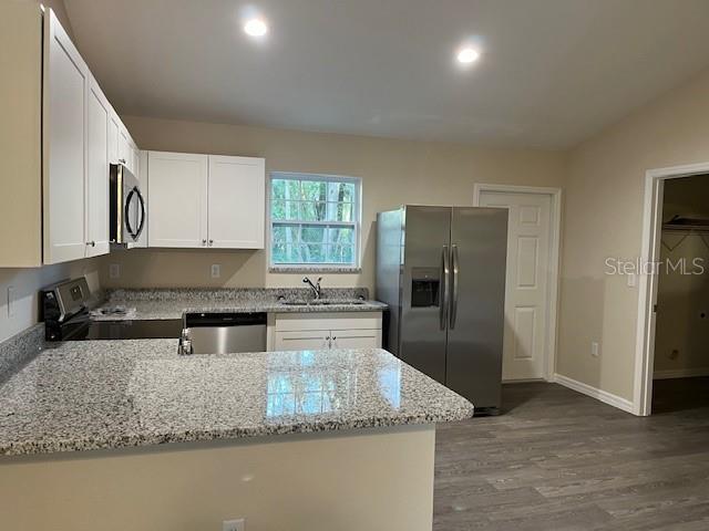 4366 Southeast 138th Street Summerfield, FL 34491 - Photo 5 of 23 a kitchen with stainless steel appliances granite countertop a sink a refrigerator and a granite counter tops