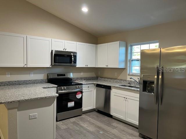 4366 Southeast 138th Street Summerfield, FL 34491 - Photo 8 of 23 a kitchen with a sink stove and refrigerator