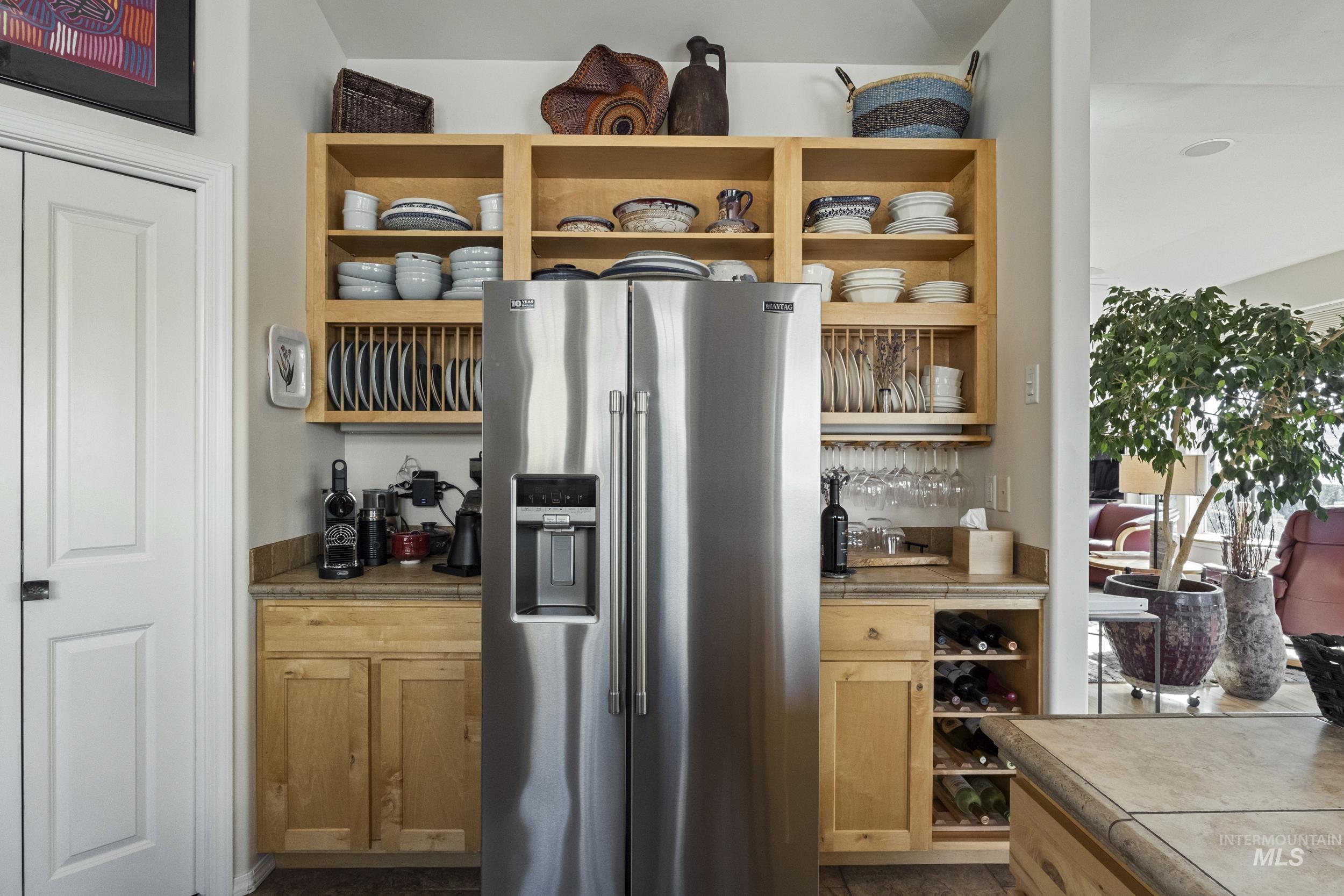382 River Road Bliss, ID 83314 - Photo 12 of 46 Indoor dry bar featuring high end fridge, tile countertops, and open shelves