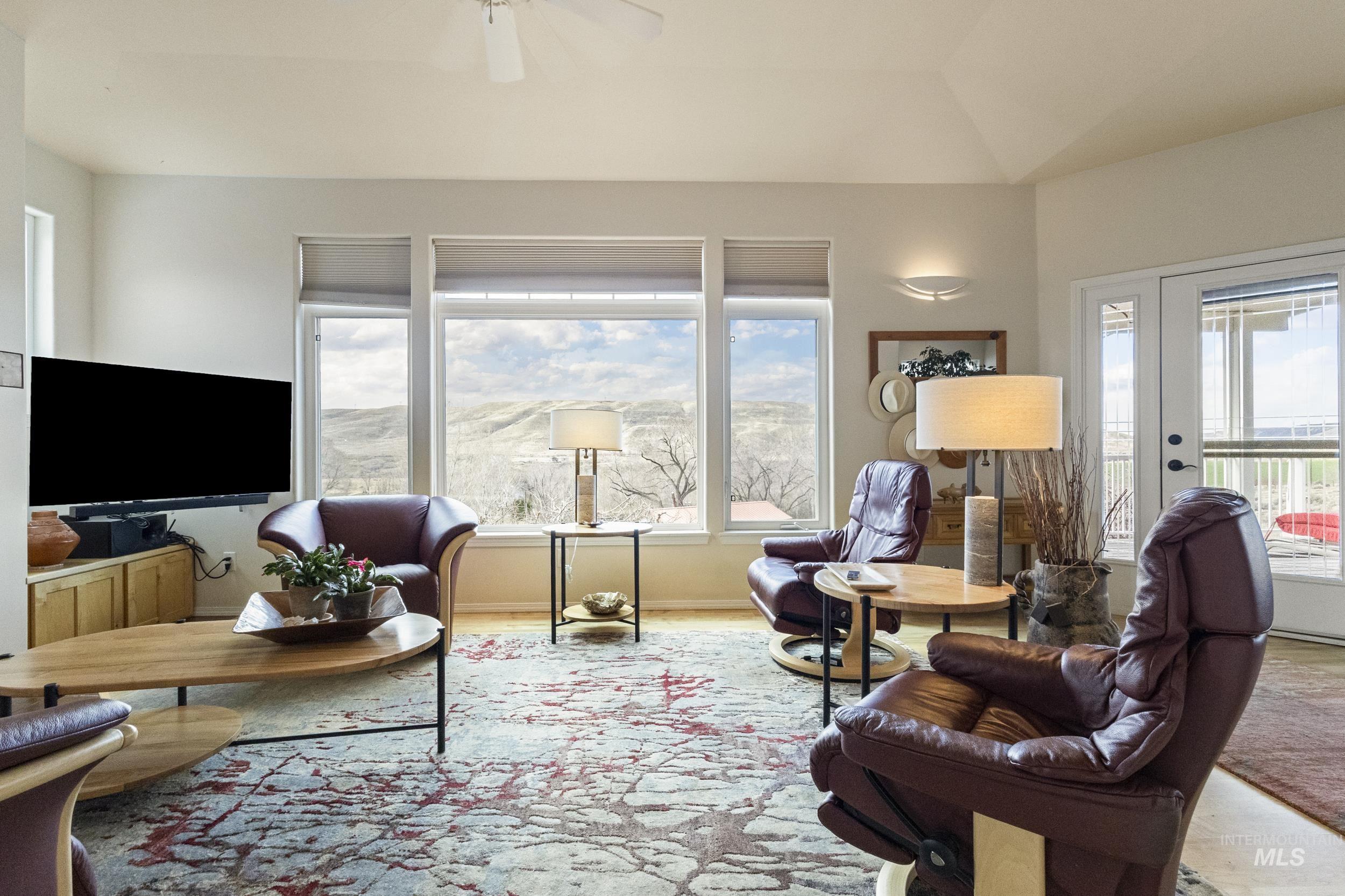 382 River Road Bliss, ID 83314 - Photo 15 of 46 Living room featuring plenty of natural light, wood finished floors, ceiling fan, and lofted ceiling