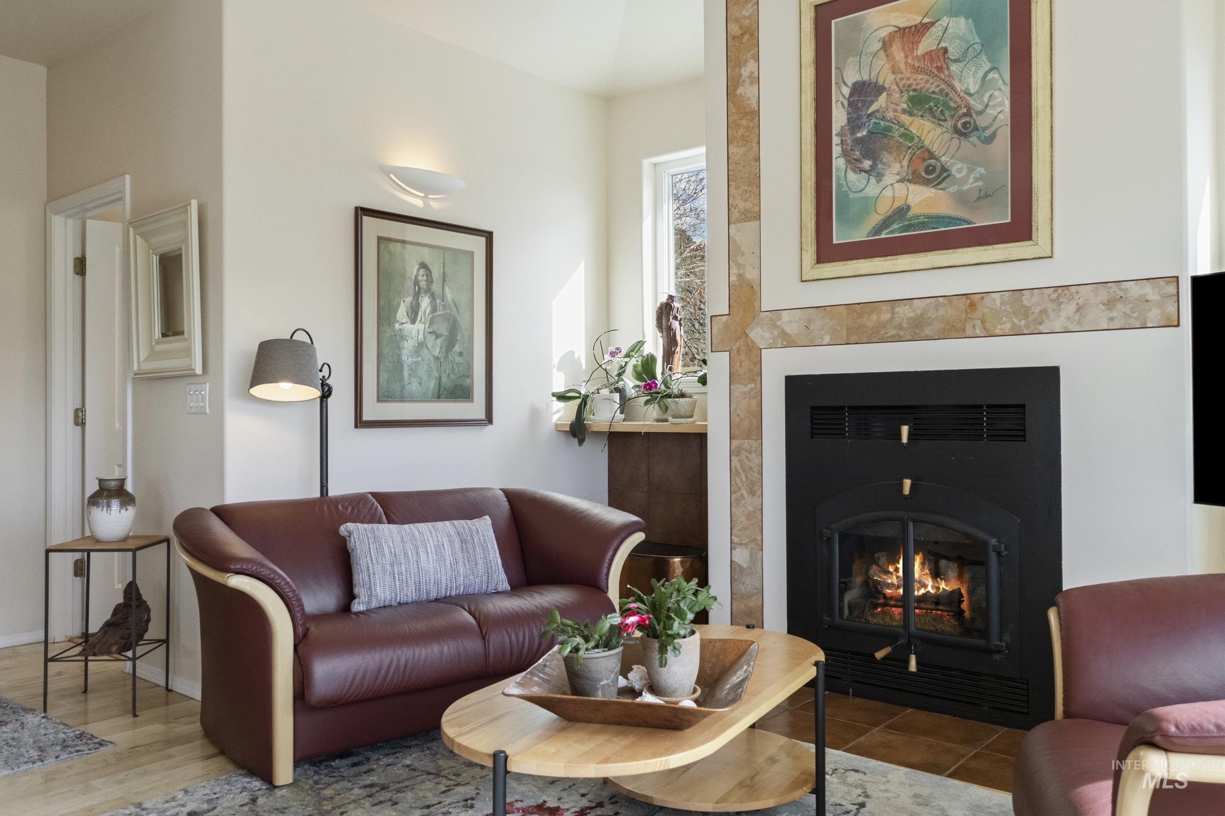 382 River Road Bliss, ID 83314 - Photo 17 of 46 Living area with a lit fireplace