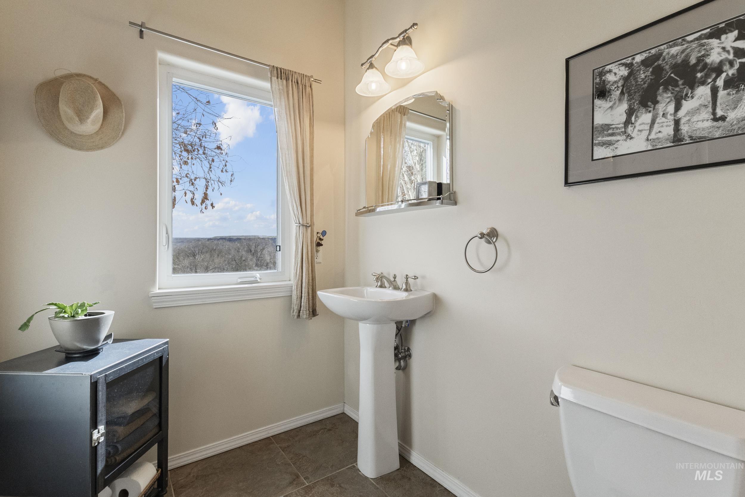 382 River Road Bliss, ID 83314 - Photo 29 of 46 Bathroom featuring plenty of natural light and dark tile patterned flooring