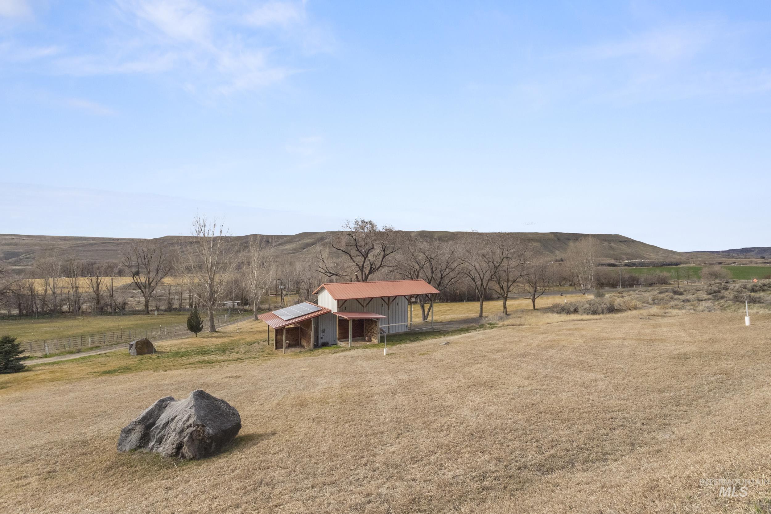 382 River Road Bliss, ID 83314 - Photo 37 of 46 View of green lawn with a view of rural / pastoral area, an outdoor structure, and a mountain view