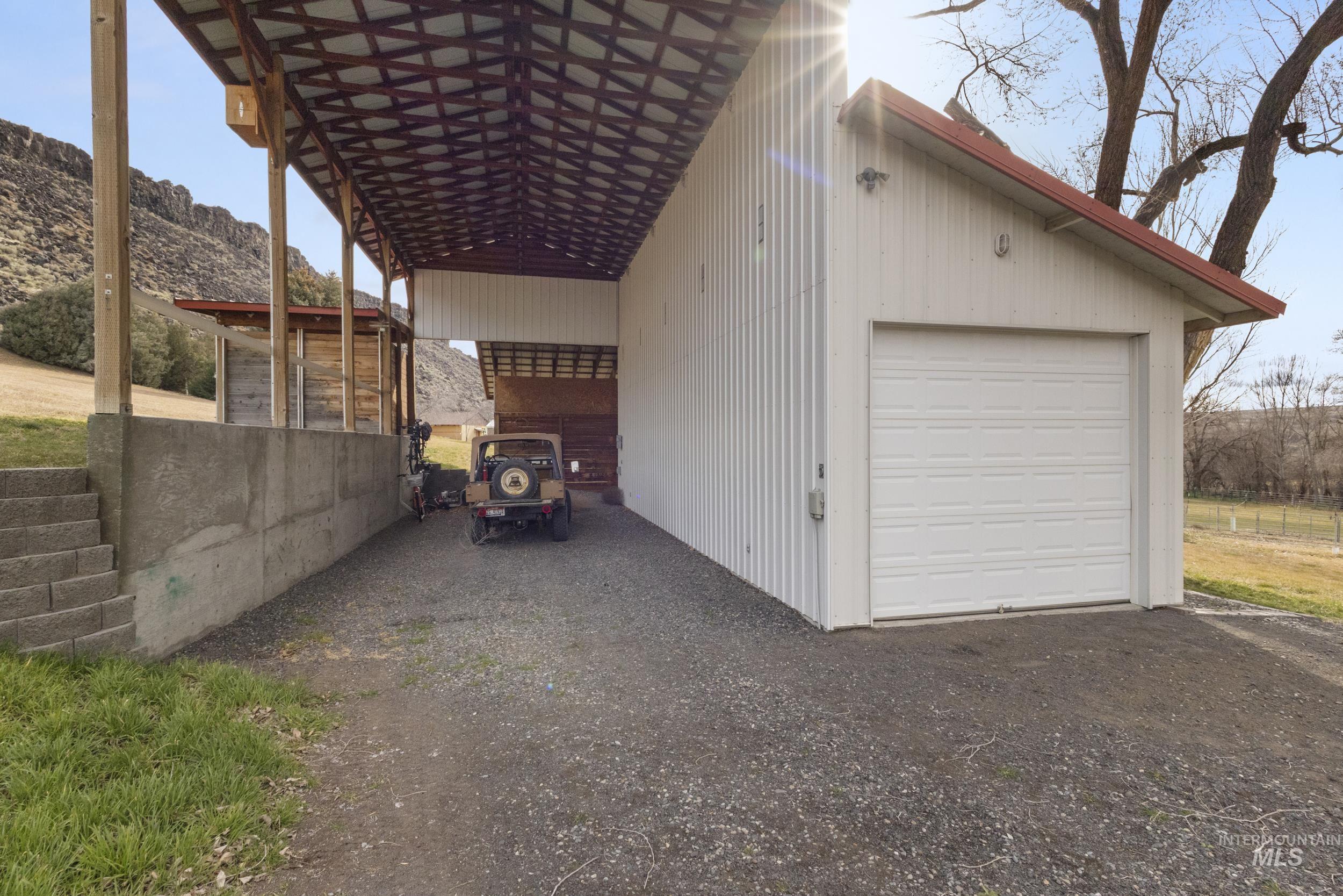 382 River Road Bliss, ID 83314 - Photo 40 of 46 Garage with a mountain view, a garage, and driveway
