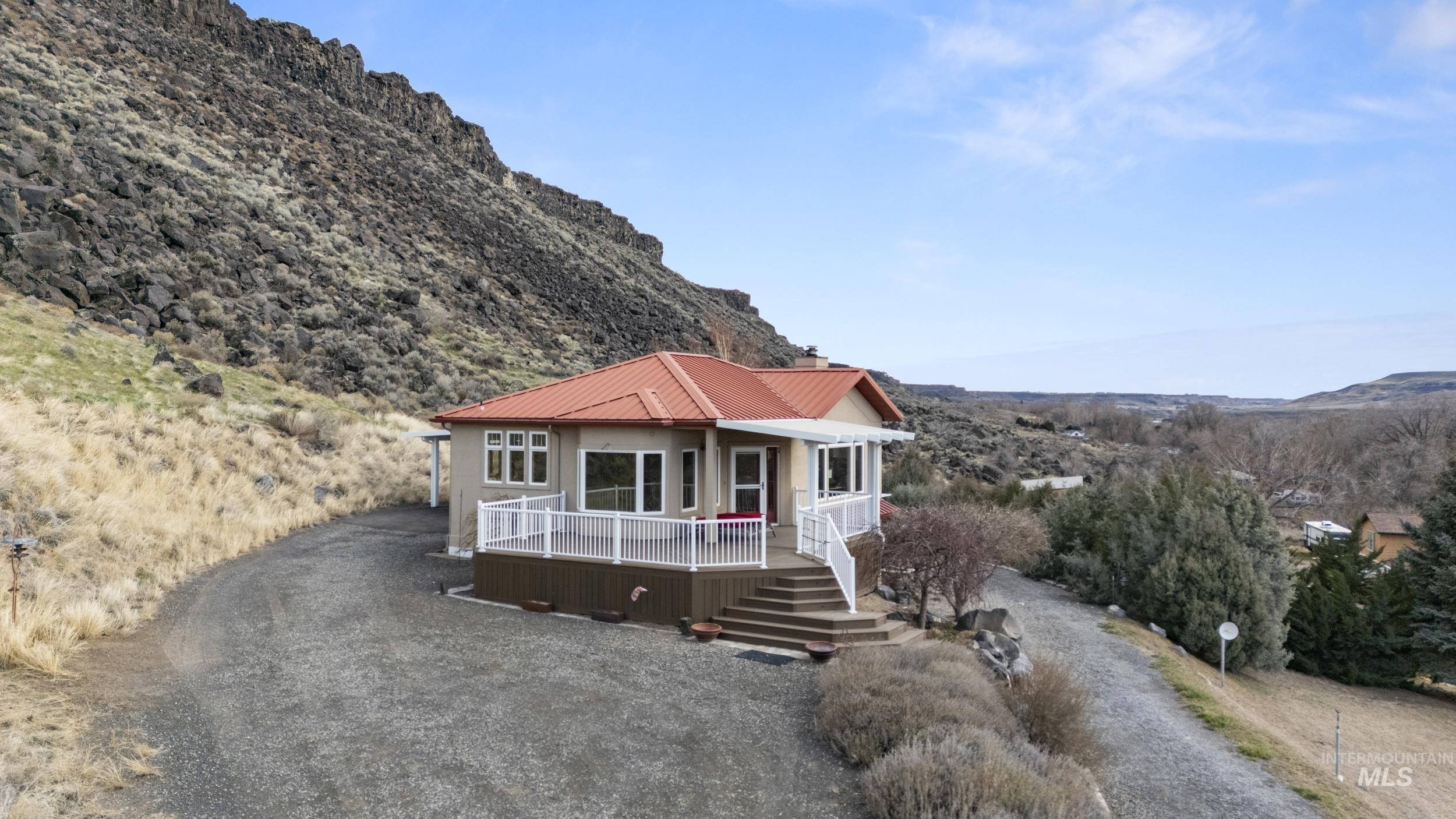 382 River Road Bliss, ID 83314 - Photo 42 of 46 View of front of property featuring a metal roof, a deck with mountain view, and driveway