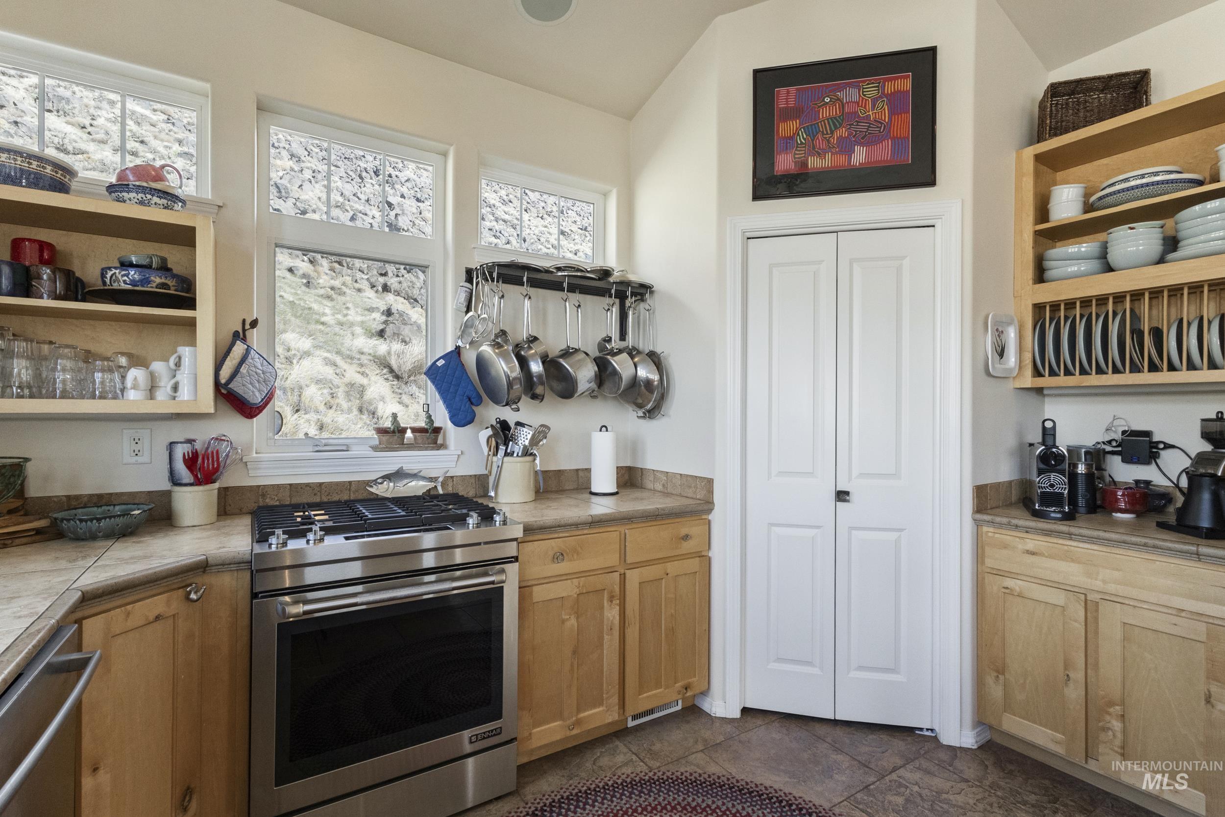 382 River Road Bliss, ID 83314 - Photo 10 of 46 Kitchen featuring open shelves, stainless steel appliances, and tile countertops