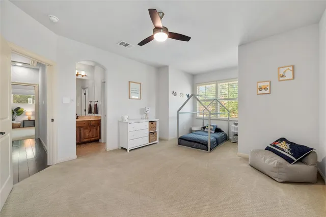 a bedroom with furniture and a large window