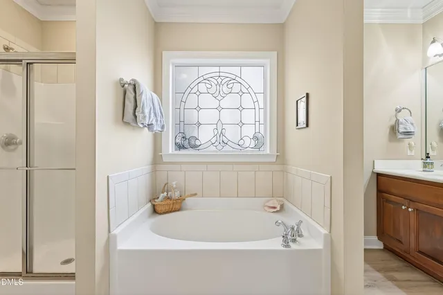 a view of a hallway with wooden floor and a living room