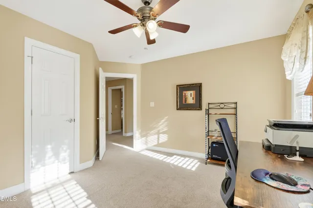 a view of a hallway with wooden floor and a window