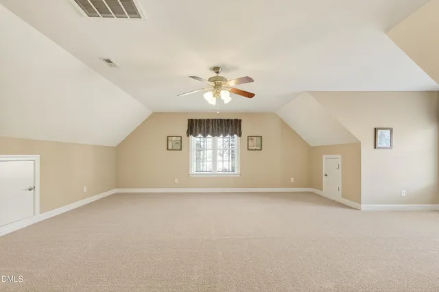 a view of a yard with wooden fence