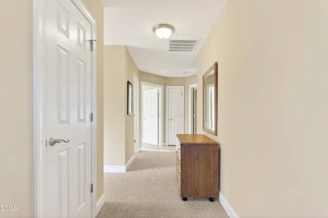 a front view of a house with a yard and large trees