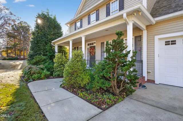 a view of a dining room with furniture a chandelier and wooden floor