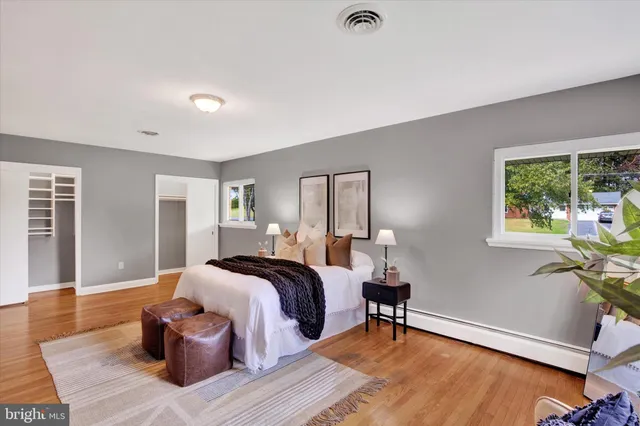 a bathroom with a toilet sink a mirror and shower