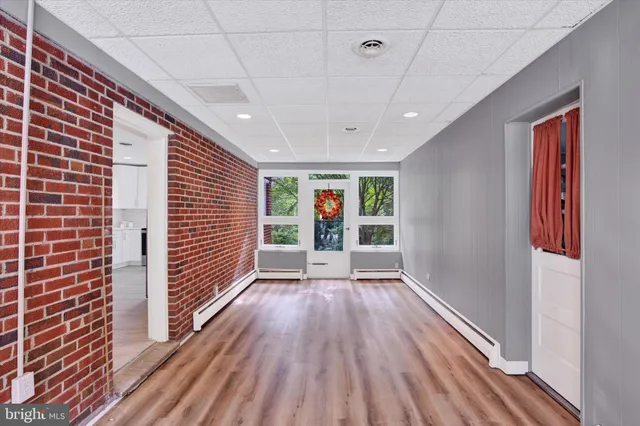 a view of hallway with wooden floor