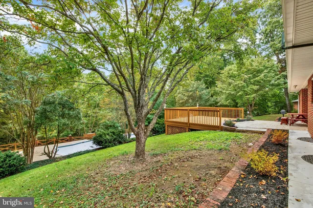 an aerial view of a house with a yard basket ball court and outdoor seating