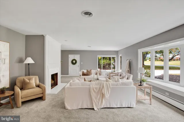 a living room with furniture and a fireplace
