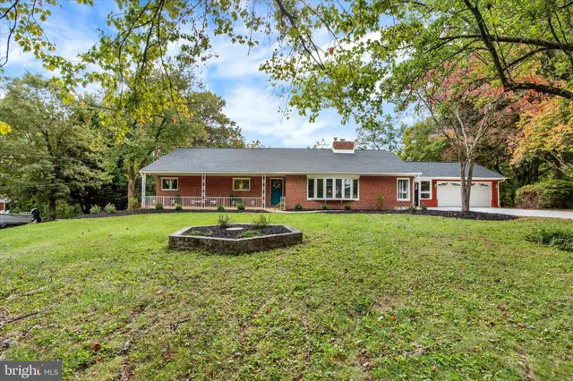 an aerial view of a house with yard swimming pool and outdoor seating