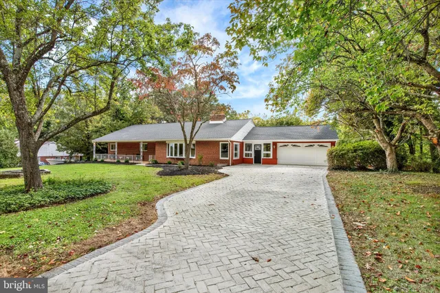 an aerial view of a house with a yard and garden