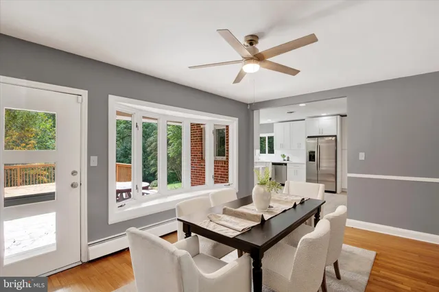 a dining room with furniture and a large window