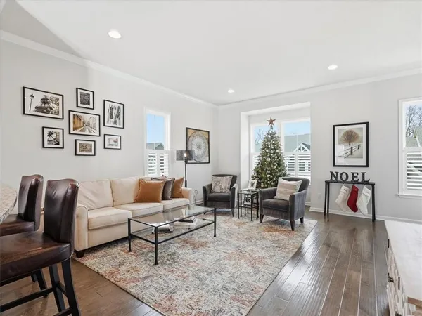 a living room with furniture and view of kitchen