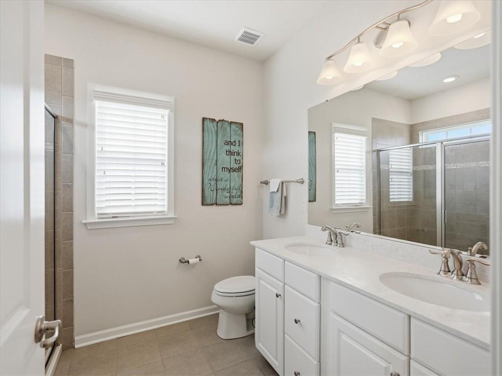 828 Oneida Circle Mars, PA 16046 - Photo 20 of 30 a bathroom with a double vanity sink a toilet and a mirror