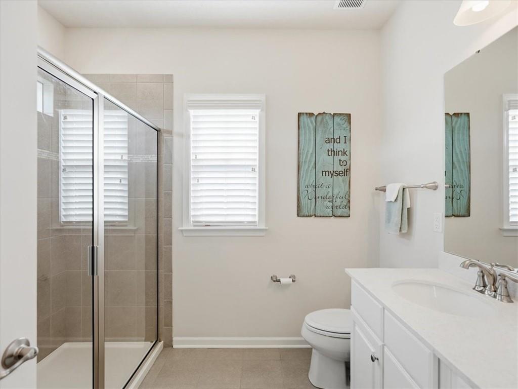 828 Oneida Circle Mars, PA 16046 - Photo 21 of 30 a bathroom with a toilet a sink and a large mirror