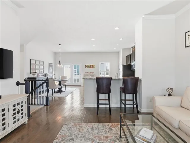 a dining room with furniture and wooden floor