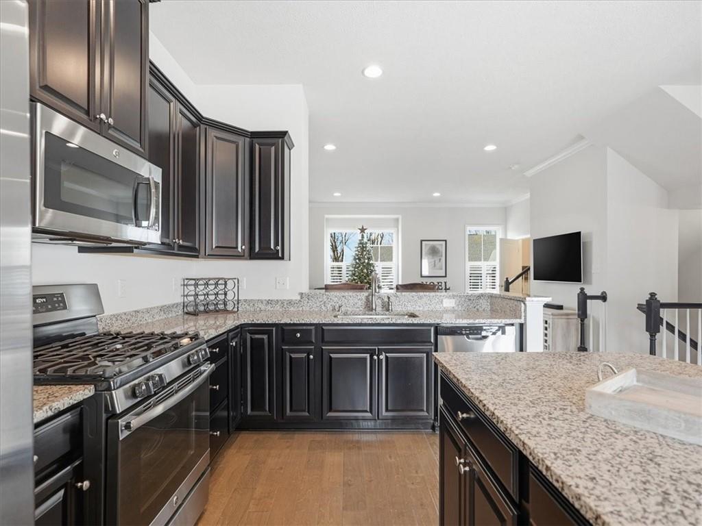 828 Oneida Circle Mars, PA 16046 - Photo 10 of 30 a kitchen with stainless steel appliances granite countertop a sink stove and microwave