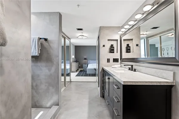 a en suite bathroom with a sink double vanity and a mirror