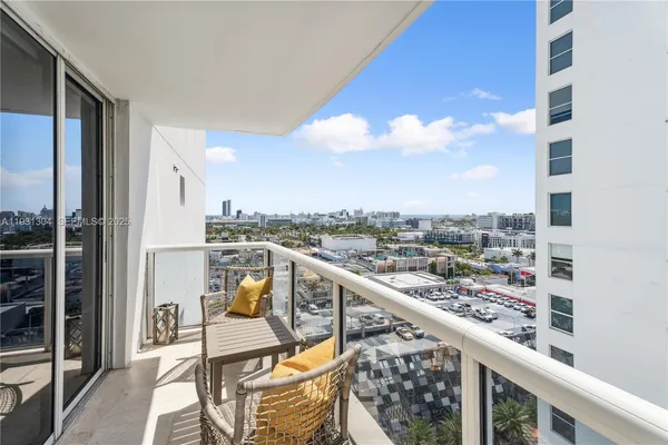 a view of a balcony with wooden chairs