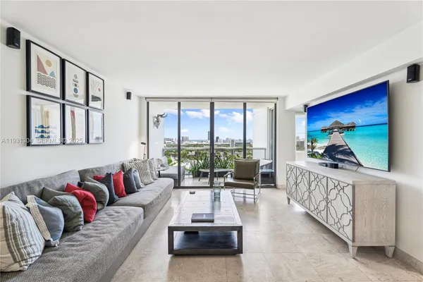 a living room with furniture fireplace and a large window