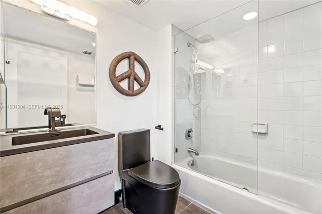 a bathroom with a sink a toilet and a bathtub