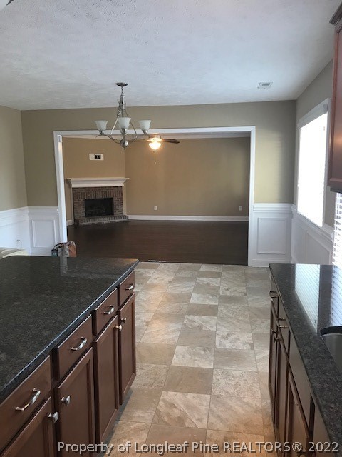 3331 Thrower Road Hope Mills, NC 28348 - Photo 5 of 25 a kitchen with a sink a stove cabinets and wooden floor