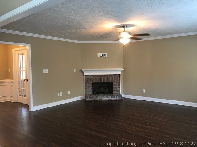 3331 Thrower Road Hope Mills, NC 28348 - Photo 10 of 25 a view of an empty room with wooden floor fireplace and a window