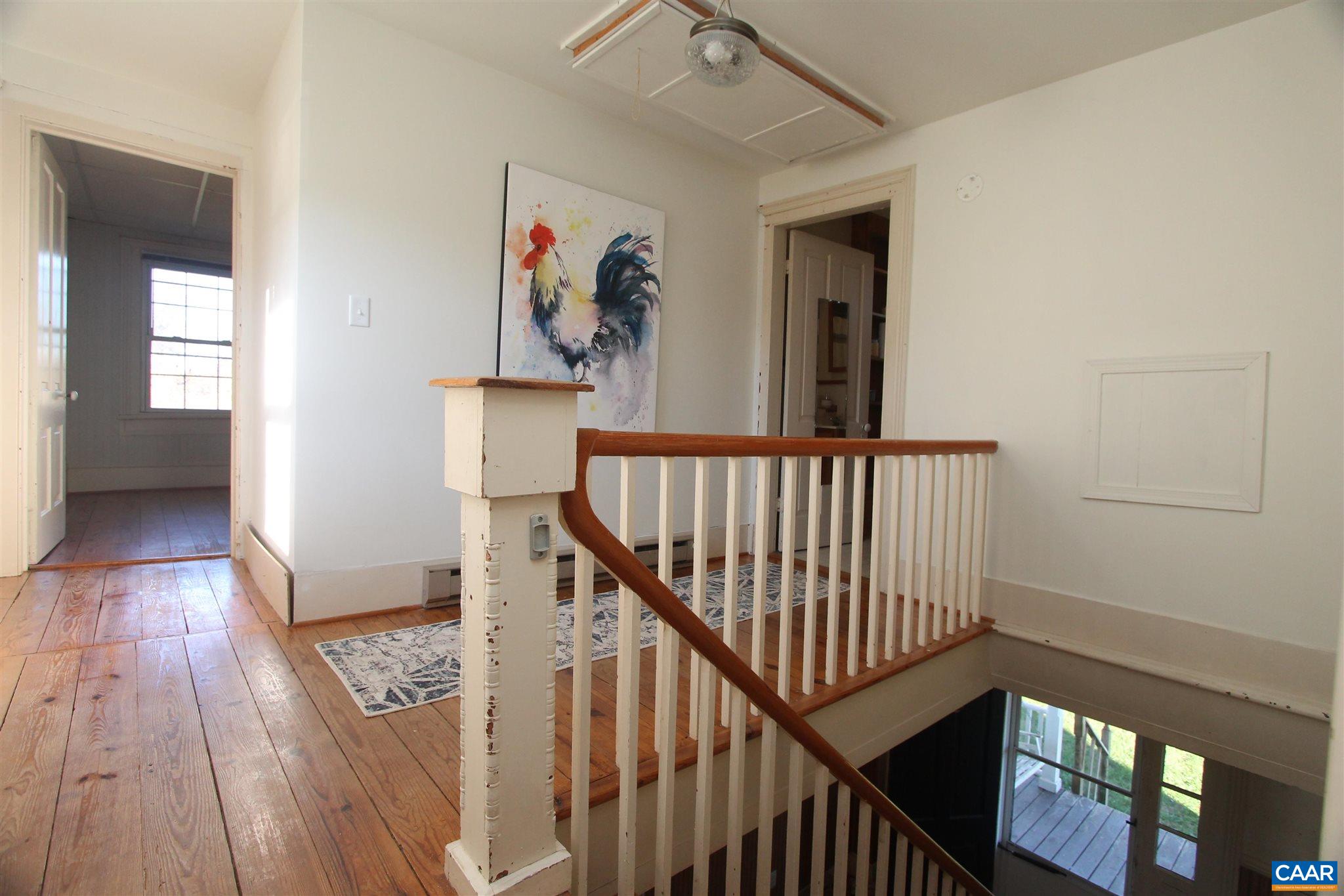 355 Gibbs Road Madison, VA 22727 - Photo 17 of 33 a view of a hallway with wooden floor and stairs
