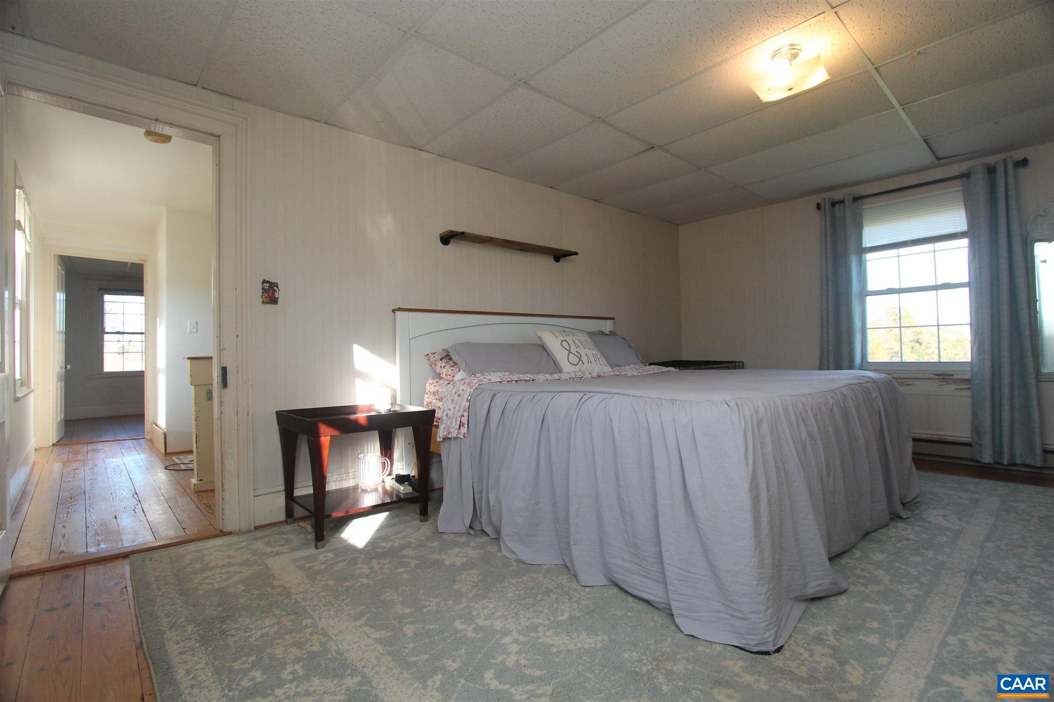 355 Gibbs Road Madison, VA 22727 - Photo 18 of 33 a bedroom with a bed and a mirror