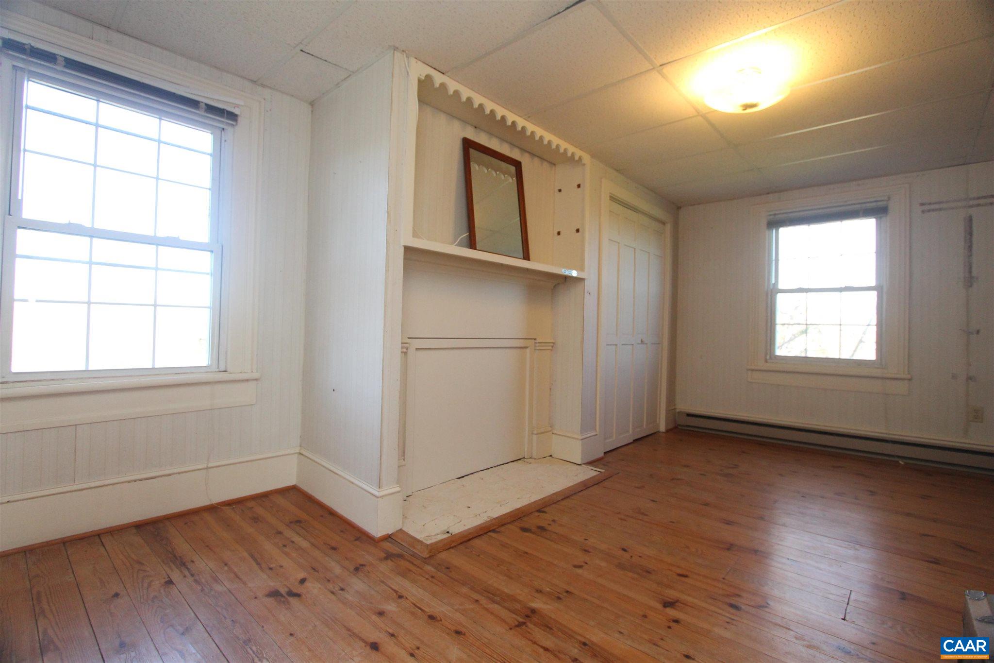 355 Gibbs Road Madison, VA 22727 - Photo 23 of 33 an empty room with wooden floor cabinet and windows