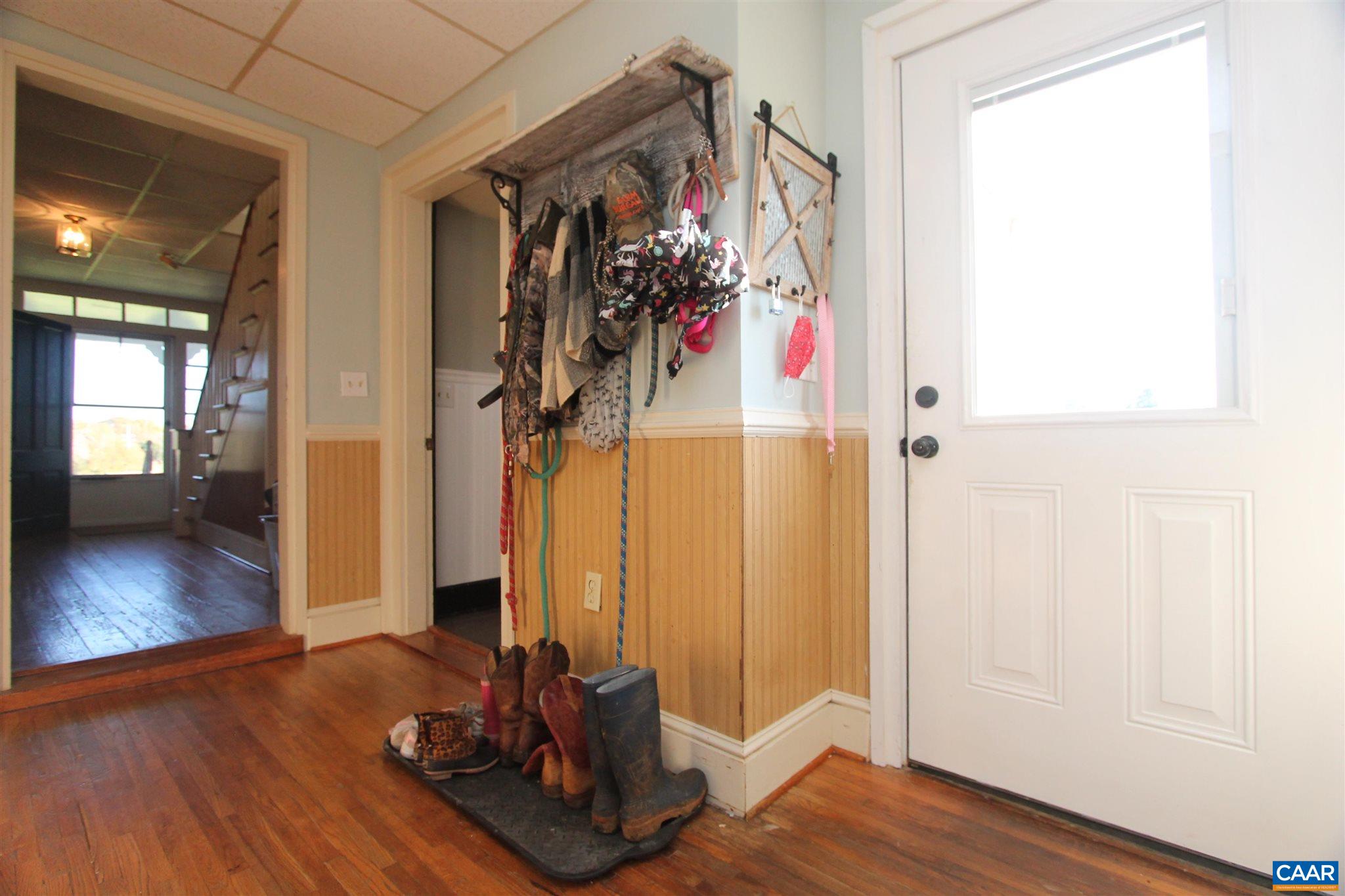 355 Gibbs Road Madison, VA 22727 - Photo 4 of 33 a view of a hallway with wooden floor and a living room