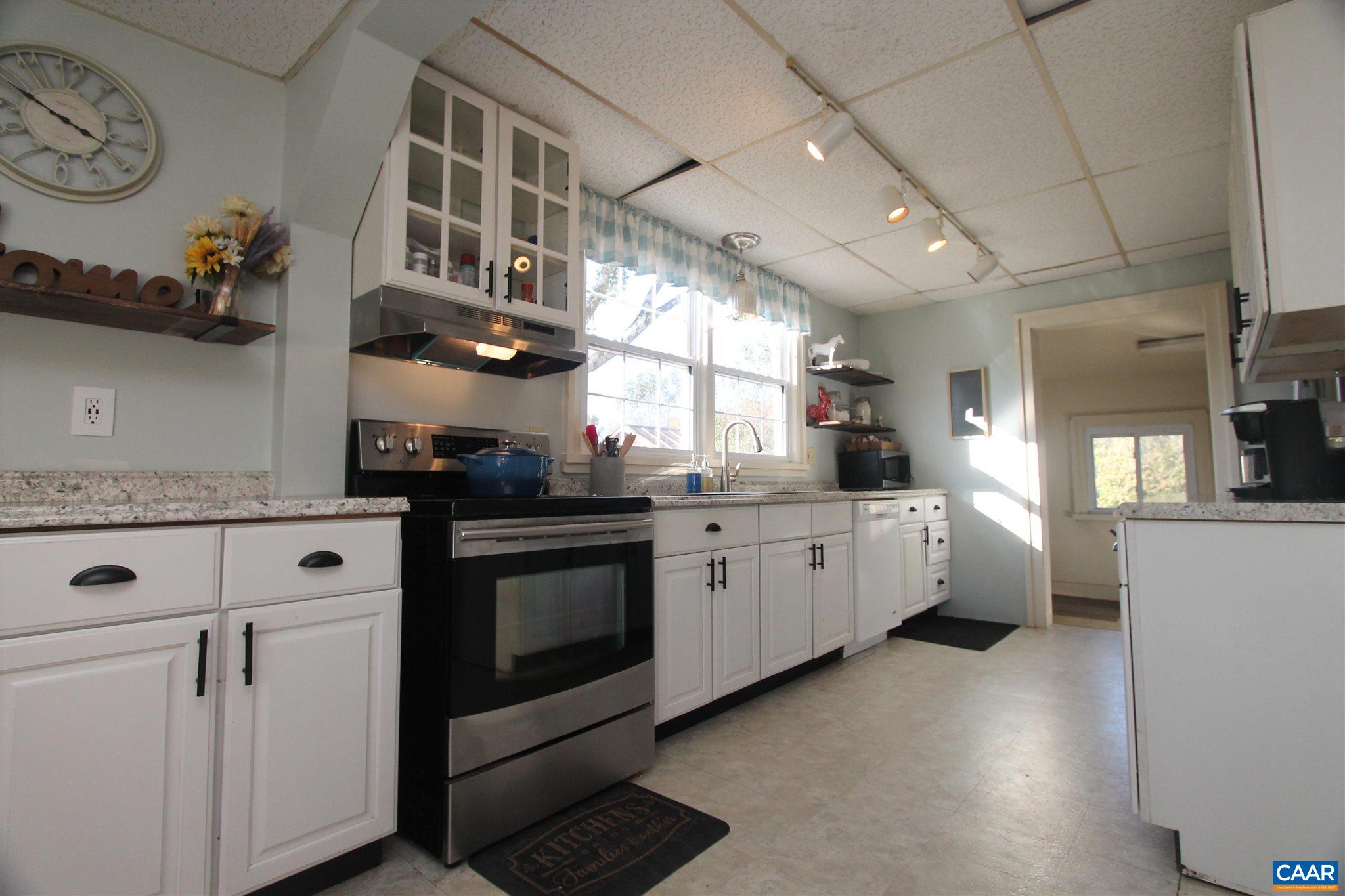 355 Gibbs Road Madison, VA 22727 - Photo 5 of 33 a kitchen with stainless steel appliances white cabinets and wooden floors